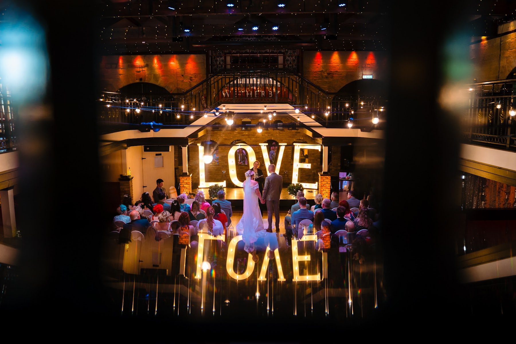 Illuminated LOVE letters glowing across the darkened room